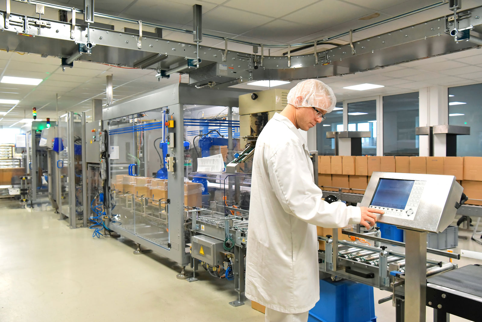 Man in a cleanroom viewing information on a screen